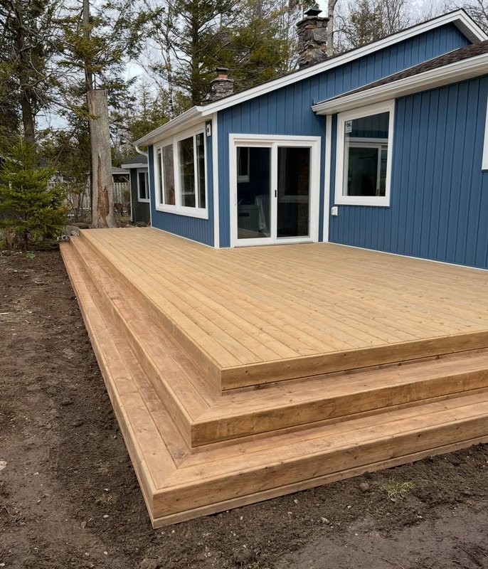 Large wood deck on blue house