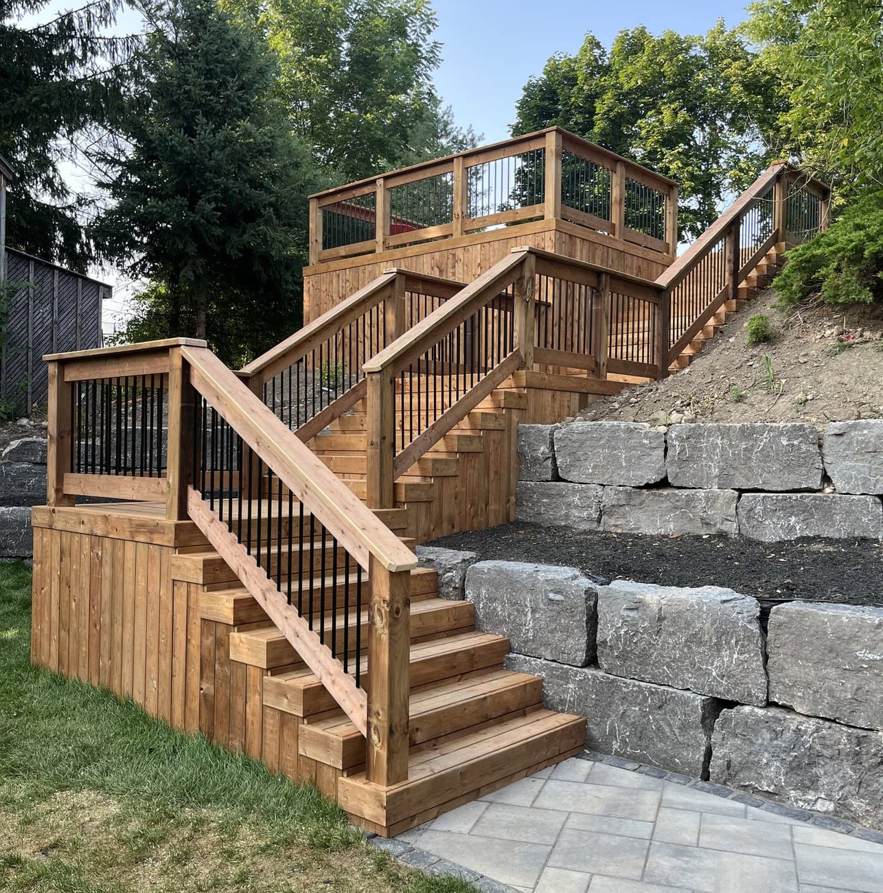 Cedar deck stairs with stone retaining wall