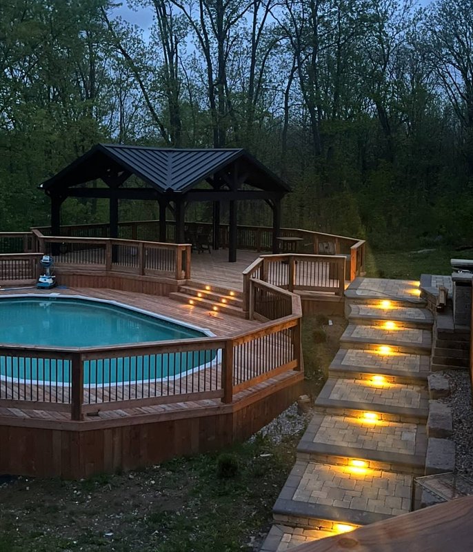 Pool deck with gazebo at dusk